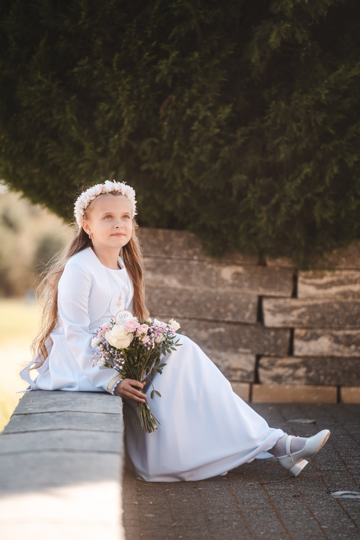 Dziewczynka z bukietem podczas fotografowania po Pierwszej Komunii Świętej